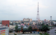 A tall tower surrounded by numerous buildings