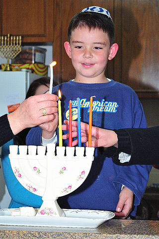 File:CHILD LIGHTING HANUKA CANDLES.jpg